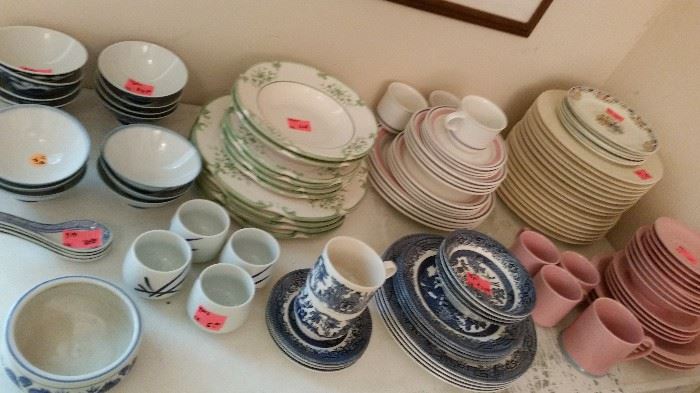 Various earthenware and porcelain dinner sets.