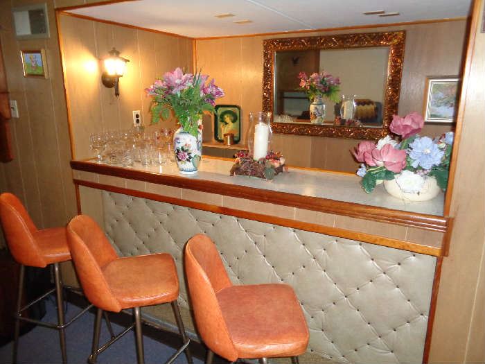 3- 1950's retro bar stools, large copper finish frame beveled mirror, bar glasses, vases and flowers