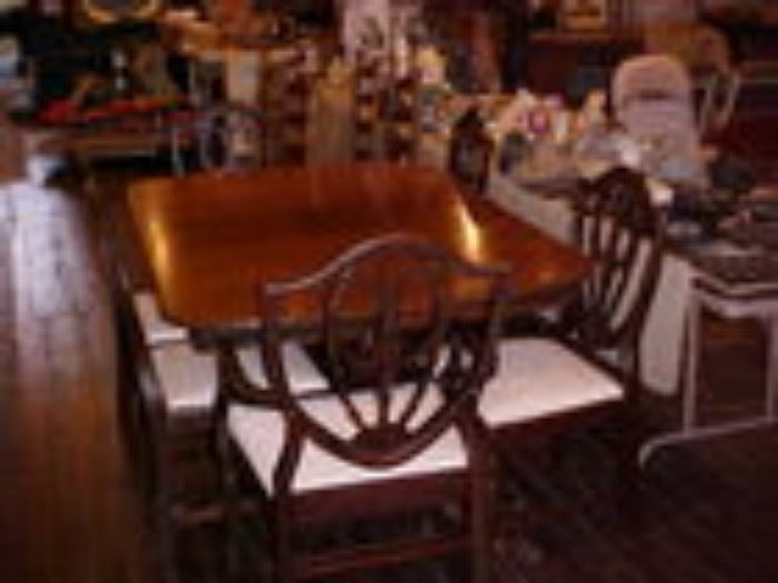 Mahogany dining table w/6 shield back chairs.