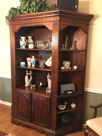 Quality curio from Thomasville, lots of shelvingand 2 cabinets in front . Space saver, can be used as corner u it. This piece is at our Elgin sale. Not at this sale, at upcoming sale.