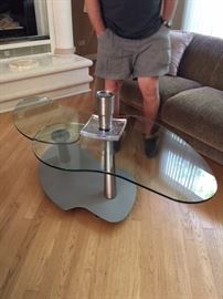 Coffee table that will turn and twist. Glass and chrome, quality item. $75