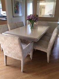 Gorgeous dining room table buffet and chairs. Paid $$$$$. Table needs to be in large room, table is one piece. Contemporary style, sleek champagne color with 6 side chairs, 2 arm chairs, all chairs custom fabric. ASKING $2000.00