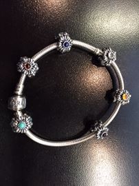 PANDORA Sterling silver bracelet and charms. The charms are also Sterling, 6 Birthday bloom charms. Little stones in the middle of a flower. New, never worn. Paid almost $400 ASKING $200