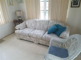 White and pastels sleeper sofa. Mattress inside, have yet to see condition. One of two wicker chairs, very sturdy and great condition. One of 4 very nice lamps. Bombay company vintage drop leaf mahogany side table. 