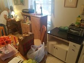 Black and white cabinet with wine bottle rack, to the left of that is a kitchen (or office or bedroom) cabinet and separate hutch. Oak and whitewash finish. Very classy. 