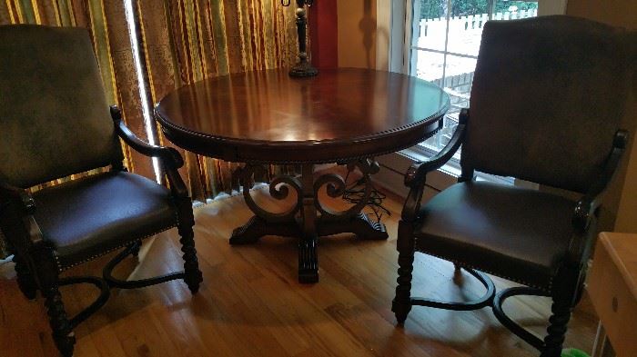 Beautiful ornate round dining table, 2 Louis IV style leather/suede armchairs w/ nail head trim.