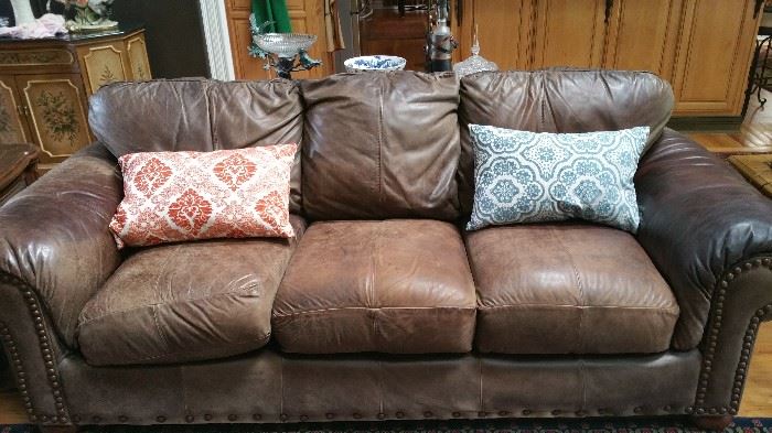 Large oversized chocolate brown leather sofa with nail head trim. 