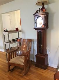 Oak rocking armchair, tall case clock Howard Miller.