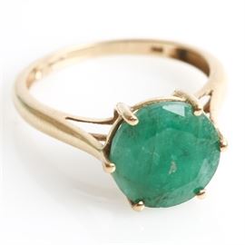 10K Yellow Gold and 2.75 CTS Emerald Ring: A 10K yellow gold ring featuring one center 2.75 cts round cut emerald mounted in a high prong setting.