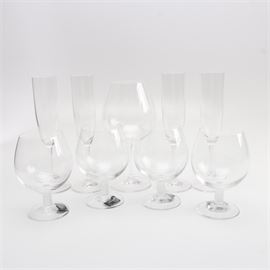 Collection of Stemware Including Mikasa: A Collection of Stemware. The collection includes four champagne flutes, a single red wine glass, and four Mikasa brandy sniffers.