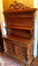 19th c. Italian sideboard with highly carved griffins, north wind faces, fruit and floral decorations with Catalan mythical female dragon vibrio atop