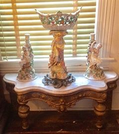 Serpentine marble top pier mirror console, French porcelain candlesticks, German porcelain centerpiece 
