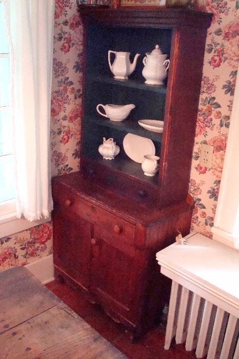 Small antique walnut wall cupboard and vintage stoneware.