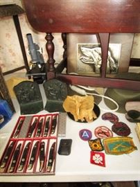 Knives (new in boxes), B & H bookends, signed metalwork dog, military patches & collectibles