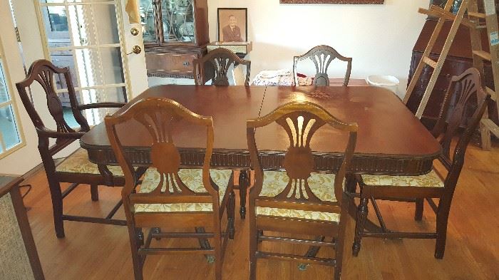 Antique table with 6 chairs and leaf to i crease length.