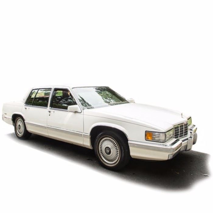 1992 Cadillac Sedan de Ville: A white full size 1992 4-door Cadillac Sedan de Ville; VIN is 1G6CD53B9N4315202 and with 91,475 miles. Features include an automatic transmission, a 4.9 liter V8 gasoline engine, a vibrant red leather interior, power windows, locks, and more. The original owner’s manual along with Cadillac owner’s items are also included.