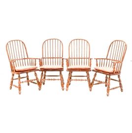 Set of Country Style Armchairs: A set of four country style armchairs, in cherry with a speckle finish. Each has an arched back, rounded back stiles, a wrap-around back rail, and lathe-turned legs with a spreader base. Each also has a removable red-orange fabric seat cushion.