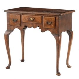 George II Style Chamber Table: A late 19th century, English George II style chamber table, in burled walnut veneers and having inlaid borders. The rectangular top has cleft-corners, over three small drawers, above a shaped apron and cabriole legs with pad feet. Circa 1880.