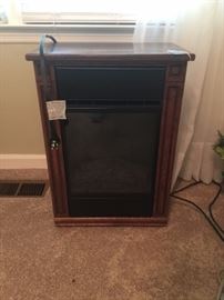 A smaller fireplace - great for a bathroom.  What a cozy heater that looks great!