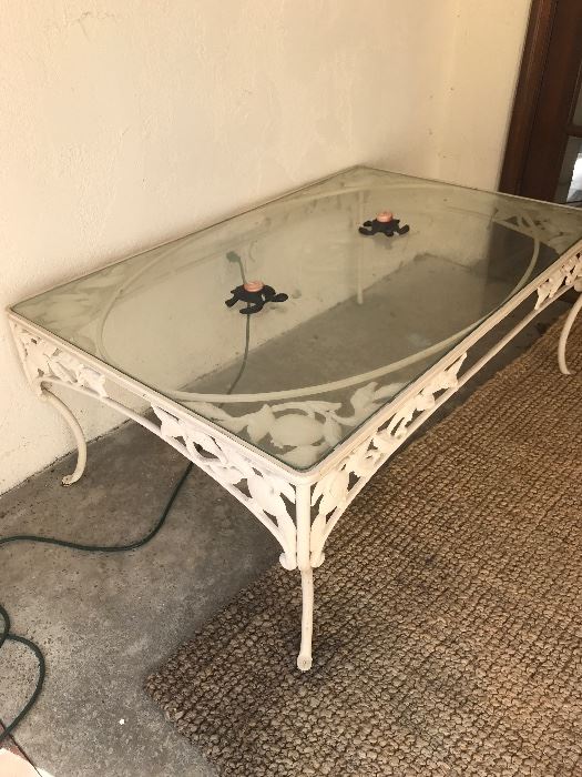 Wrought iron, glass top table-apple motif. Matches patio set