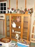 Rooster figurines and other collectibles and a display cabinet