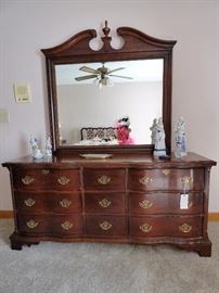 Mahogany Broyhill serpentine front triple dresser with mirror