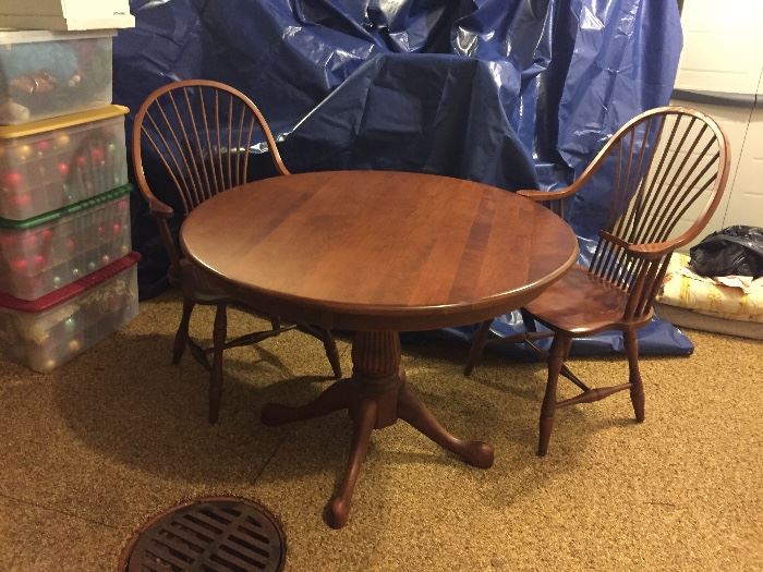 Solid wood table with two chairs.