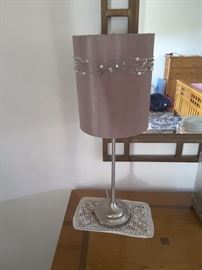 Standing lamp for dresser with decorative beads. Small doilie underneath. There are 2 of these lamps. Lamps are from Pier One.