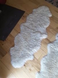 Small floor rugs, there are two of these, sheep skin. These may be vacuumed. Also may be washed delicate cycle and air dry.