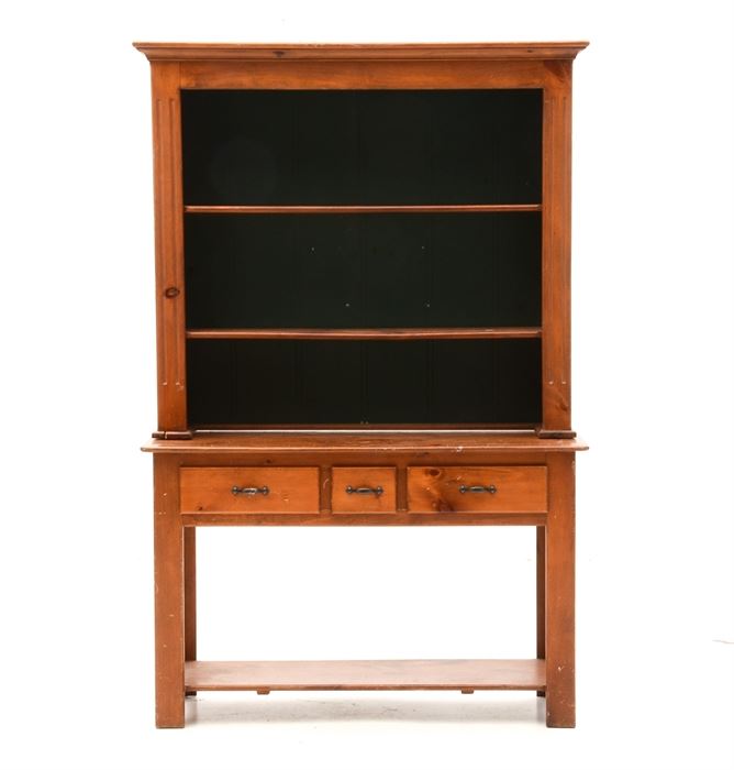 Pine Hutch-on-Table: A maple stained pine hutch-on-table in two sections, to include an upper unit, having a molded cornice, over two shelves with plate groove and a green painted back. The base unit has three drawers and a lower shelf, between straight legs.