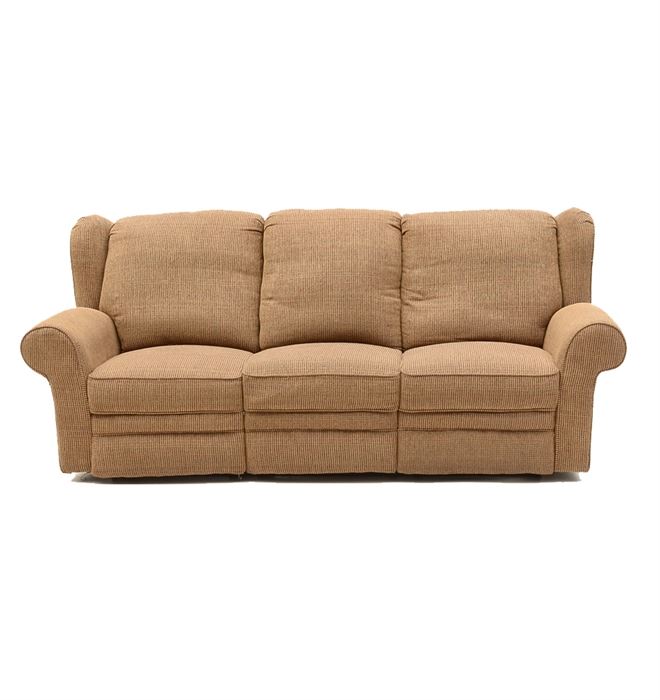 Reclining Sofa: A tight upholstered sofa, covered in a tan textured fabric and having rolled arms with three seats functioning as recliners with foot rests. Manufacturer unknown.