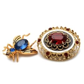 Pegasus Coro Insect Pin and Oval Brooch: A pair of mid-to-late century Pegasus Coro brooches. The insect pin is in the form of a fly or bee, accented with faceted faux gemstones. The oval brooch is crafted in a Victorian Revival style, in a tiered, openwork setting featuring deep red imitation gemstones. The insect bears the Pegasus mark, with script “Coro” within a rectangular mark. The oval brooch bears a similar mark to setting, and an indistinct script “Coro” to closure.