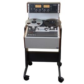 Studer Model A810 Studio Reel to Reel Tape Recorder: A Studer model A810 studio reel to reel tape recorder with rolling stand. The tape recorder features a microprocessor control system suited for studio applications, broadcasting, television and theater, having a rigid aluminum alloy chassis with a manually manipulatable head shield, electronically controlled tape tension and real-time tape timer. The editing feature offers four spooling speeds. Also includes a vinyl covered instruction manual.