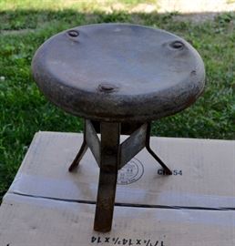 A wonderful Industrial era metal milk stool