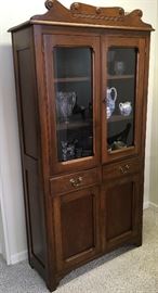 Second of two primitive  wood glass door cabinets