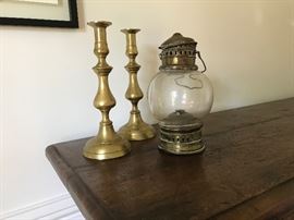 Early brass candlesticks from England and a brass mariner's light from the South of France.
