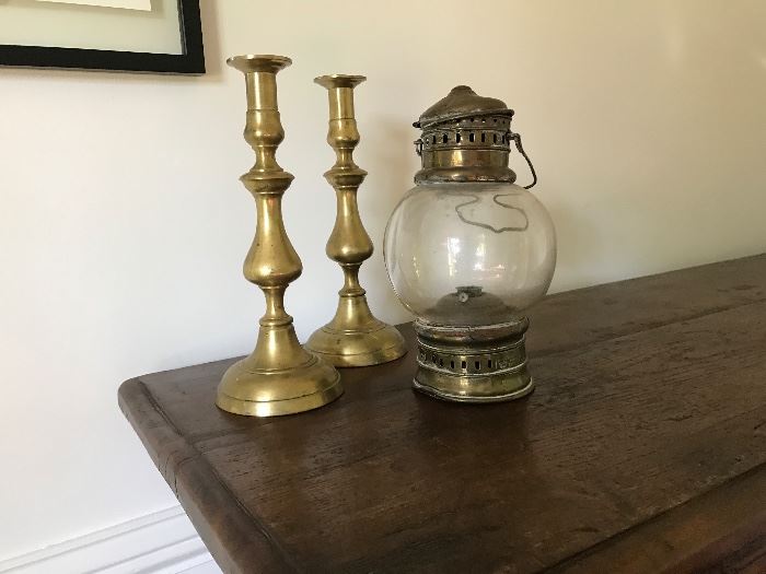 Early brass candlesticks from England and a brass mariner's light from the South of France.  