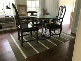 A classic dining table designed by Birmingham-based architect Bill Ingram. Features a simple wooden top, covered in a chunky, beveled glass. Perfect for use with a banquette or for small space dining. Accommodates four comfortably, or up to six with small stools. Note the beautiful Biot confit pot at rear, from the South of France.