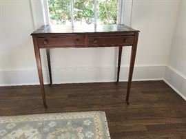 One of the highlights of this sale - a handsome Hepplewhite writing table in original condition. Beautiful patina and what appears to be the original hand-tooled leather top. Original brass casters on legs, and classic brass knobs.