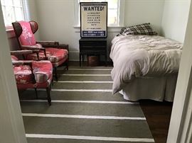 Late 19th century armchairs from the South of France, covered in a whimsical Provencal fabric. Bedside table by Lane from the 1950s, part of their 'Rhythm' collection. A rare American WWII War Bonds print in custom frame.