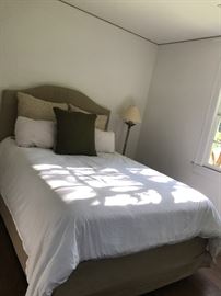 A queen-sized Parsons bed in Belgian linen upholstery by Restoration Hardware. Originally retail $1650, plus it comes with a mattress, frame and boxspring. Bedding is not included. Entire set will be $550.