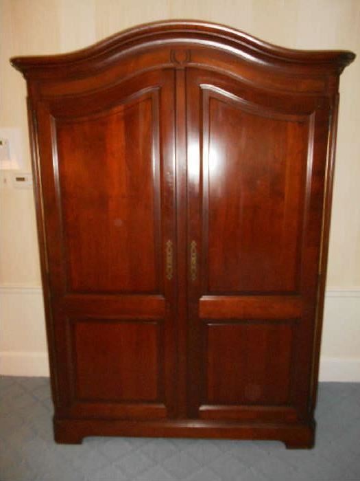 First Floor Hall:  The movers were great to bring this classic French GRANGE two-door armoire/wardrobe to the first floor hall.  You'll appreciate that rather than taking it down the curved front staircase from the upstairs bedroom!  It measures 60" wide x 24" deep x 82" tall.  Grange Furniture is a furniture shop in Monts du Lyonnais, France that was established by Joseph Grange in 1904. The company produces heirlooms using "old-world techniques" such as dove-tail jointing, hand applied wood stain and lacquer. Designs are subtle versions of those used in 17th Century chateux furniture by André-Charles Boulle and Jean-François Oeben, and other furniture from historic Provence, France homes.  This is a true French made, quality piece!