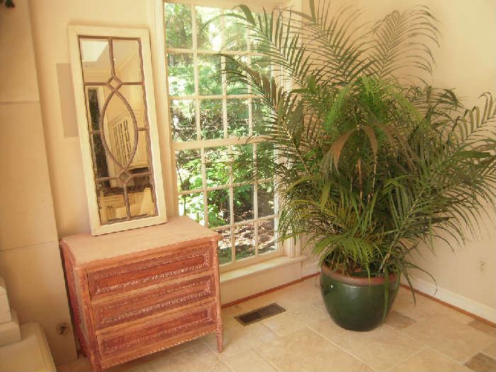 Sun Room-Atrium: This is the second chest and mirror vignette which is to the left of one of two faux plants in a 16" tall green glazed planter.