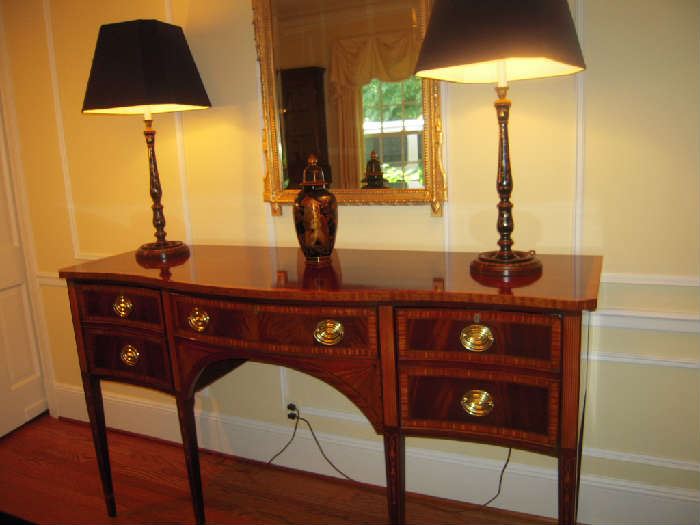 Dining Room:  The elegant COUNCILL CRAFTSMEN Federal-style sideboard is a wonderful piece of furniture--classic and complimentary to any style.  It measures 66" wide x 23" deep x 38" tall.  On top are two black/floral painted lamps and a MAITLAND-SMITH urn.