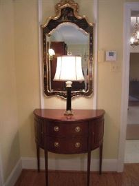 Formal Living Room:  This is one of the two identical displays (the other is on the opposite wall).  The black Chinoiserie mirror (25" wide x 48" tall) is trimmed in gold; the lamp has a heavy black glass/gold trim column; the mahogany two-drawer/two door demi-lune console is by BAKER (Historic Charleston) and measures 34" wide x 18" deep x 35" tall.