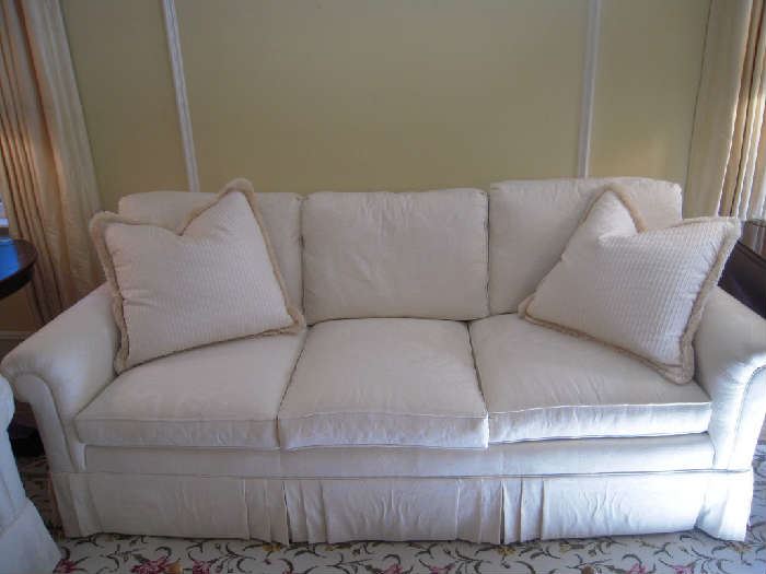 Living Room:  One of two matching 7 foot long three cushion back/three cushion seat sofas (down filled).  Two matching toss pillows are included with each sofa.