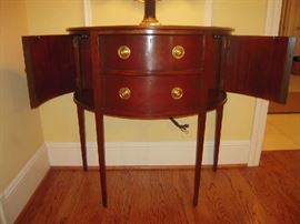 Living Room:  One of the BAKER demi-lune consoles now has its curved side doors open.  