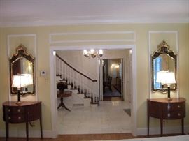 Living Room: This is a view of the living room from one end to the entry of the house.  Shown are two identical vignettes of Chinoiserie mirrors, black glass lamps, and mahogany BAKER demi-lune consoles.  Closer photos are coming up!
