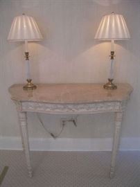 Master Bedroom-First Floor:  This serpentine front marble top console table measures 47" wide x 20" deep x 33" tall.  On top is a pair of antique brass/glass twist lamps.