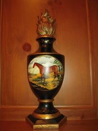 Library-First Floor:  On the mantel is a pair of flat back wall "urns" with horses. They are meant to hang on a wall but we thought they looked great resting on the mantel.  Each one has a flame design top and measures 19" tall.